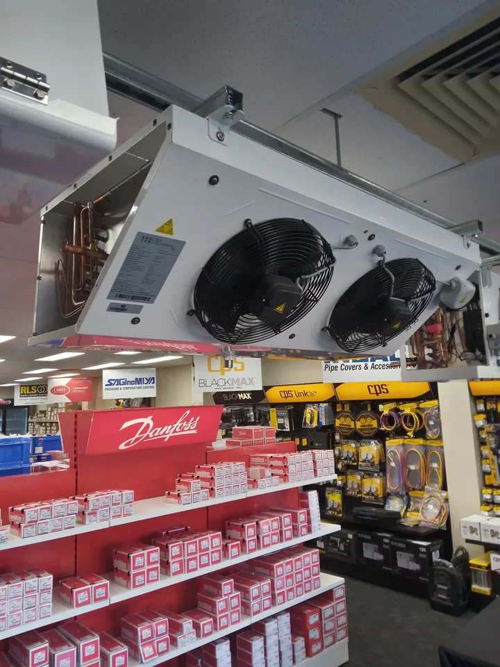 Commercial evaporator unit displayed above refrigeration equipment
