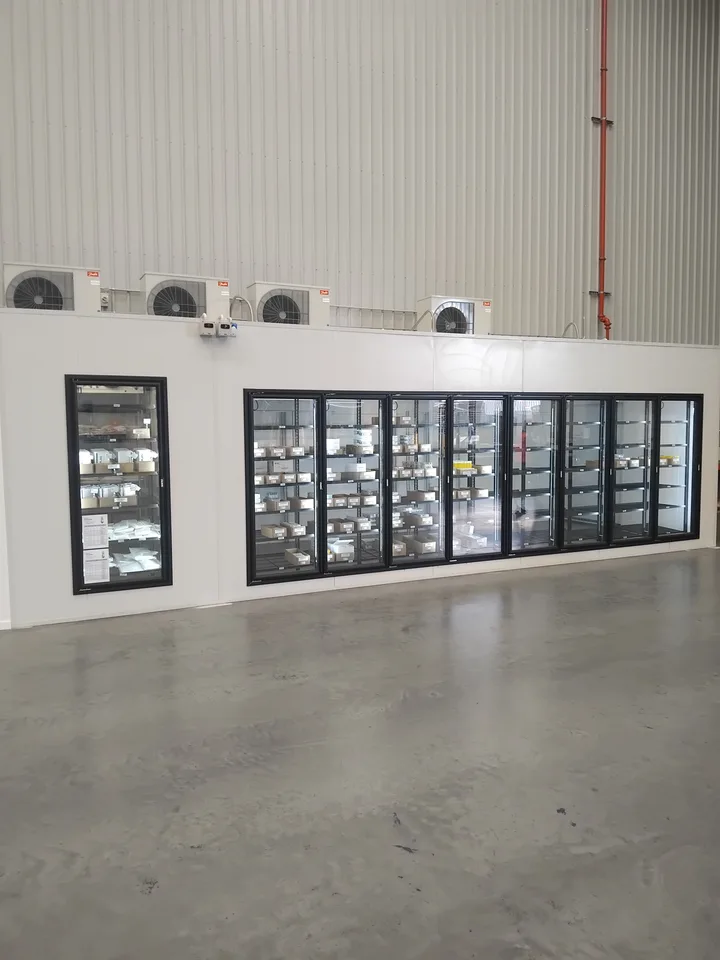 Entry to the custom dual-temperature cold storage room with shelving and refrigeration equipment