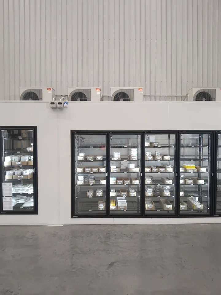 Custom dual-temperature glass-door refrigeration display with condensing units above