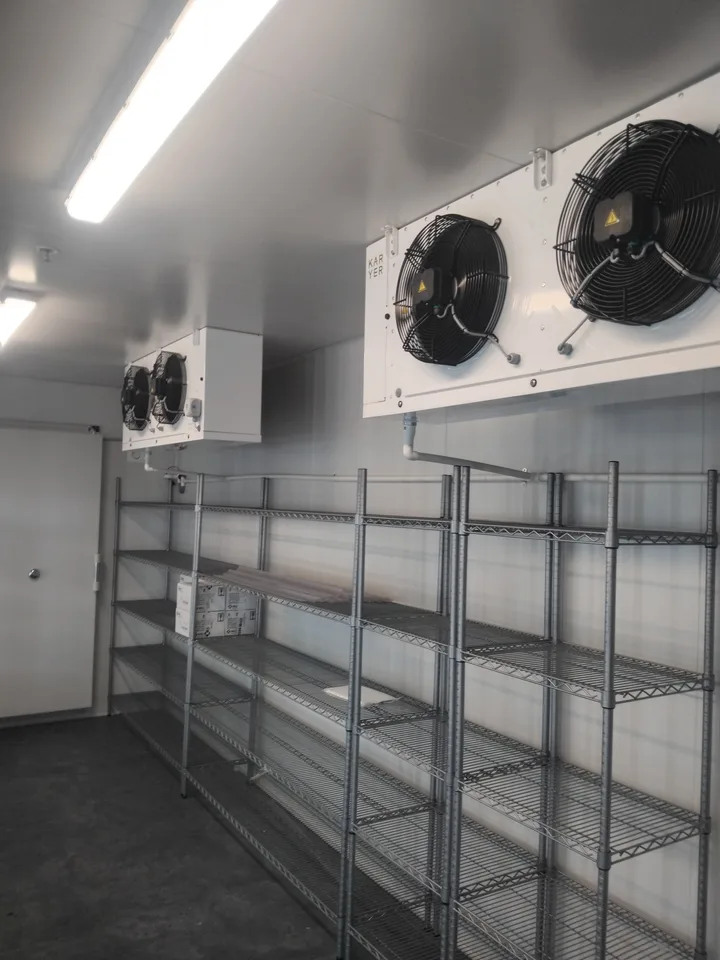 Temperature controls above the custom glass-door refrigeration display