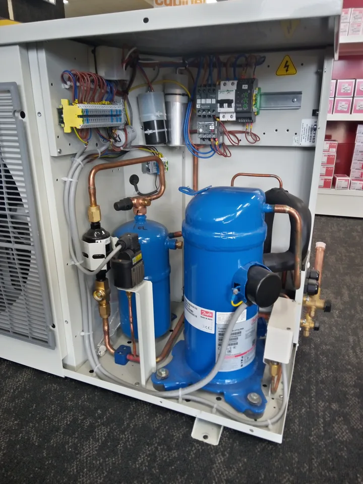 Open refrigeration condensing unit showing compressor and electrical components